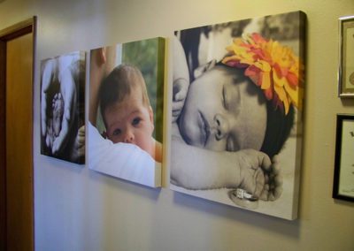 Photo of Wall Chiropractic hallway with canvas prints of infants.