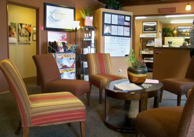 Photo of Wall Chiropractic waiting room with view of the front desk.