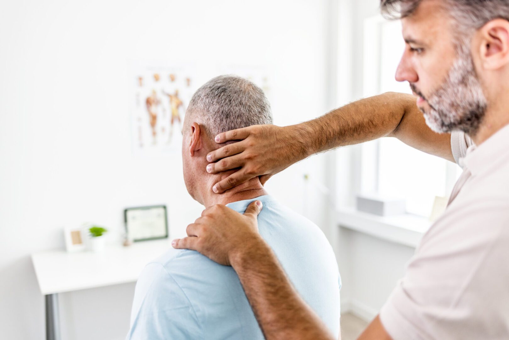 Male doctor examined the neck pain of a male patient